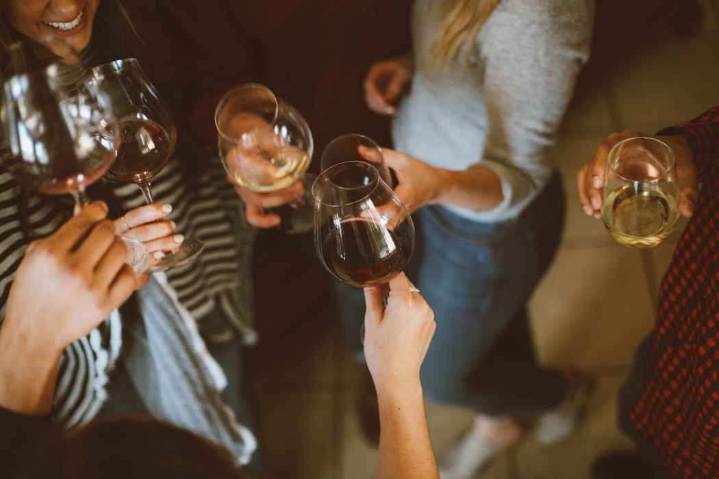 group-of-people-tossing-wine-glasses