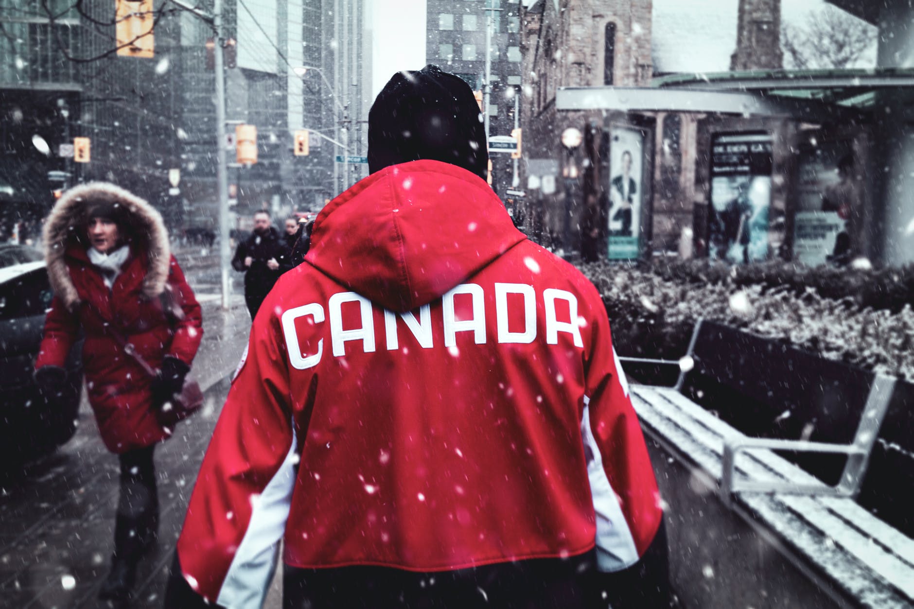 person outside wearing a coat with ‘Canada’ written on it