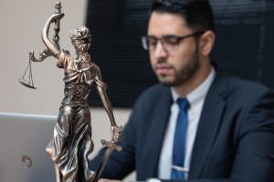 statue of Lady Justice with criminal defence lawyer in background