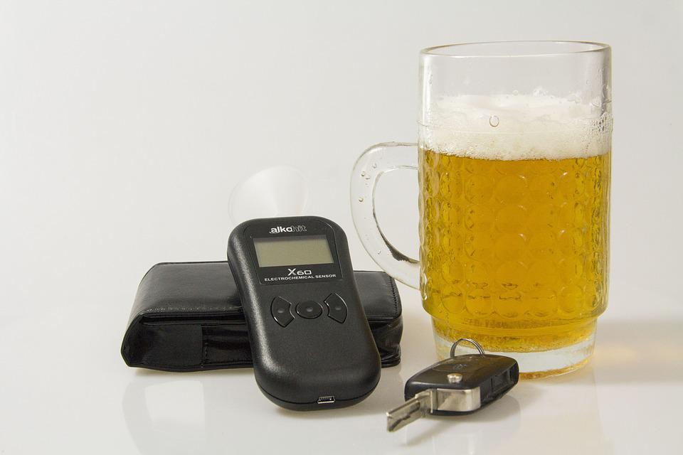 car key, breathalyzer test and glass of beer together