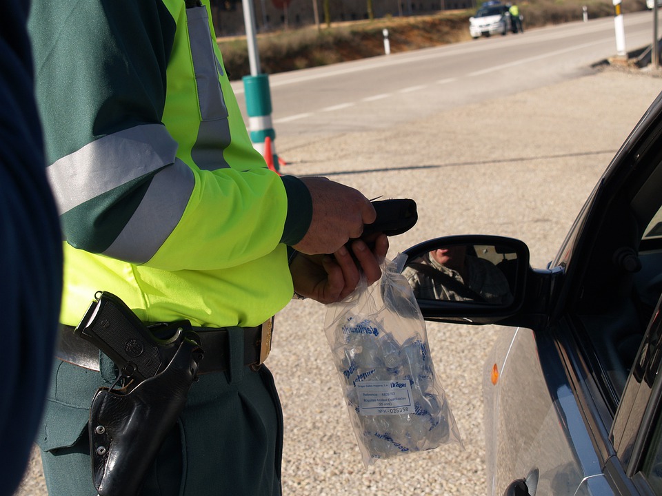 police officer administering roadside test]