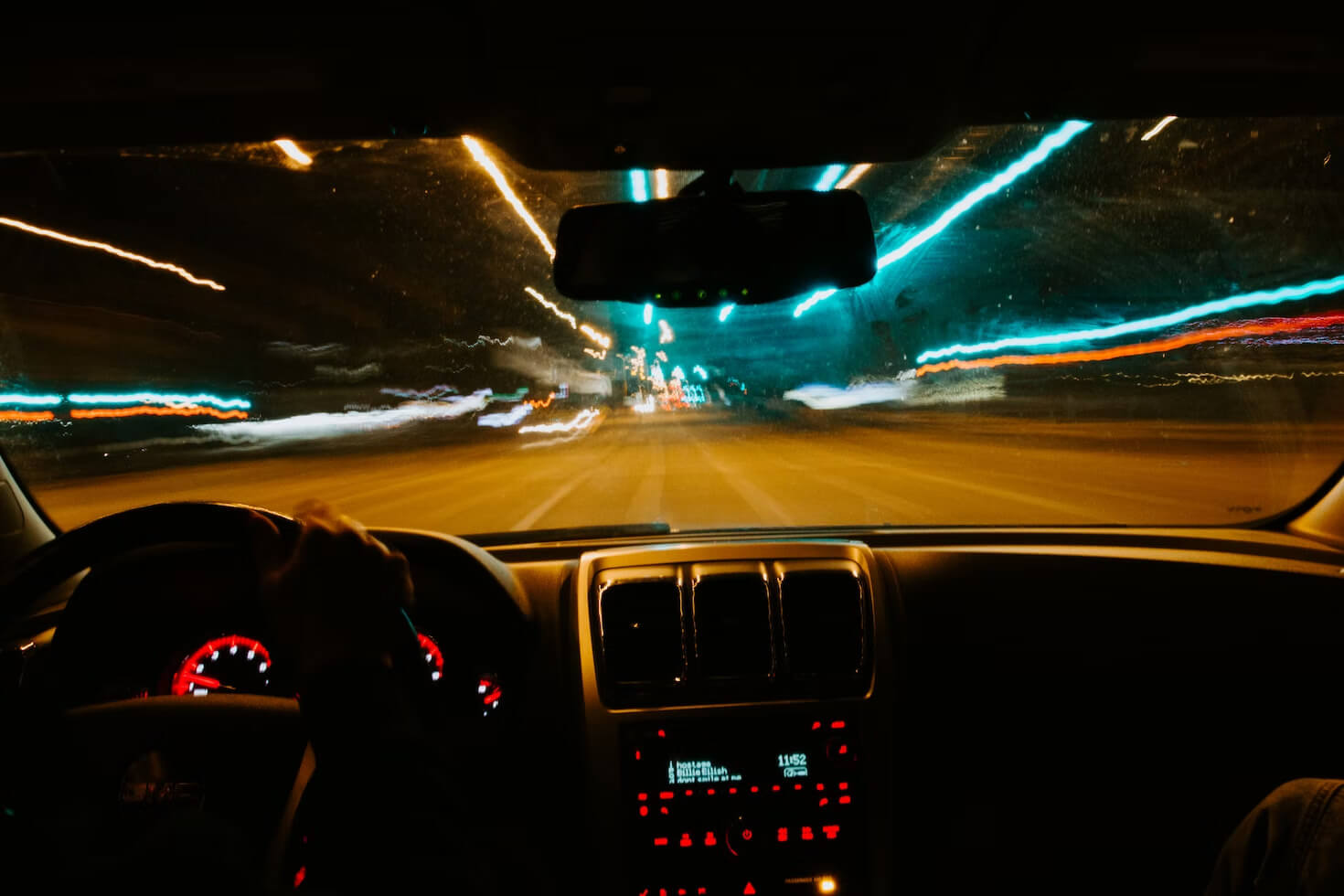 impaired driving concept image - blurred lights seen through car windshield