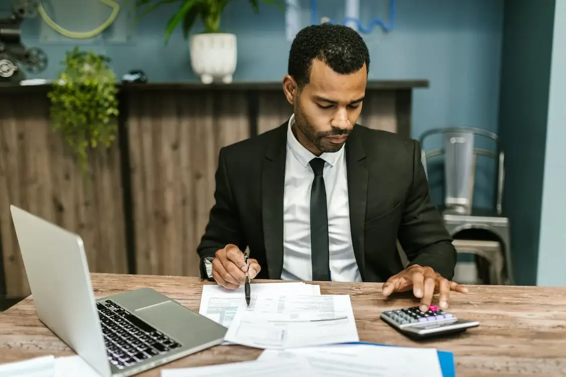 man in suit working to file tax returns