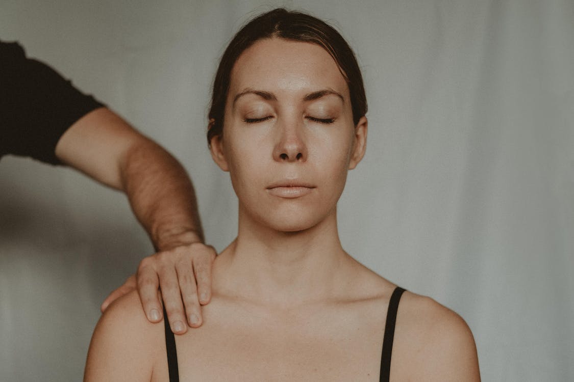 stalking concept image - woman with unknown man’s hand on her shoulder