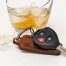 car keys next to broken glass containing alcoholic drink