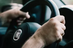 up-close view of driver’s hands on steering wheel