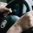 up-close view of driver’s hands on steering wheel