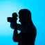 silhouette of man holding camera