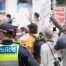 police officer in foreground, protesters in background