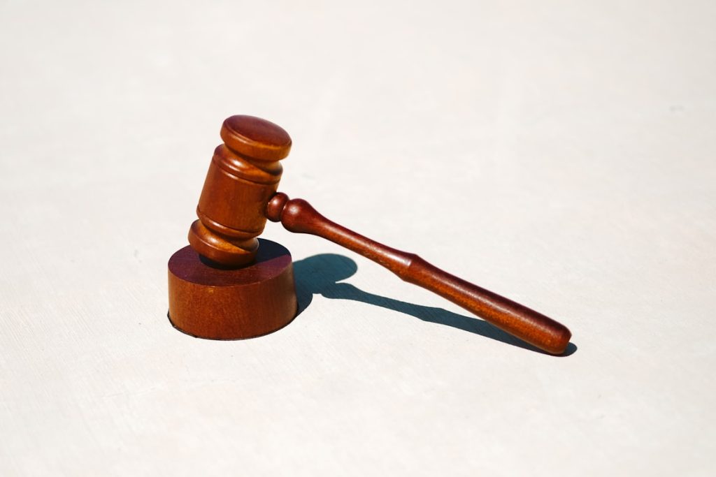 photo-1593115057322-e94b77572f20 A wooden gavel sitting on a white background