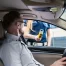 Police officer holding a breathalyzer at the window of a driver seated in his car